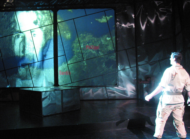 Julius Caesar — solo figure against the projected map panels