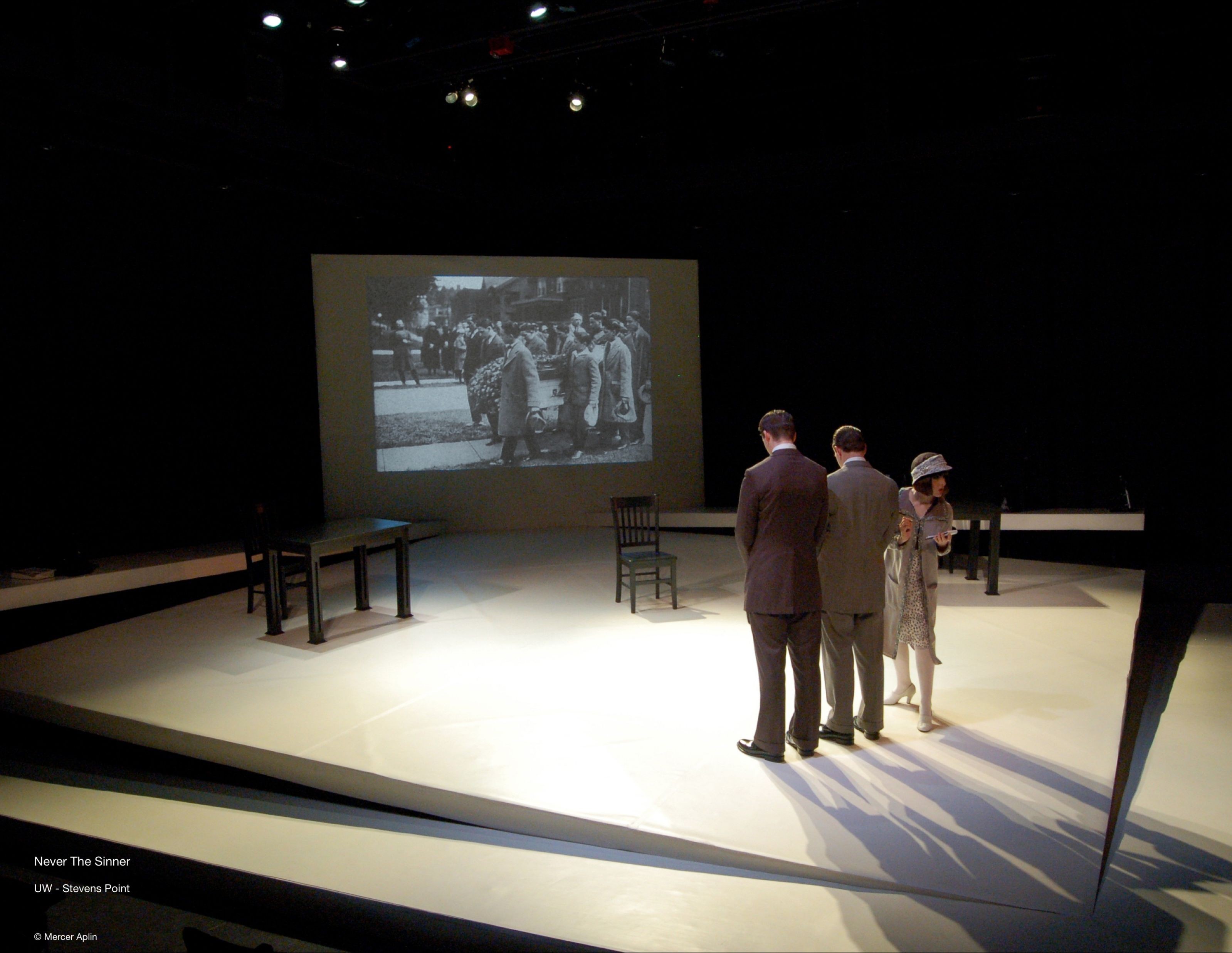 Never The Sinner — courtroom scene against period newsreel projection