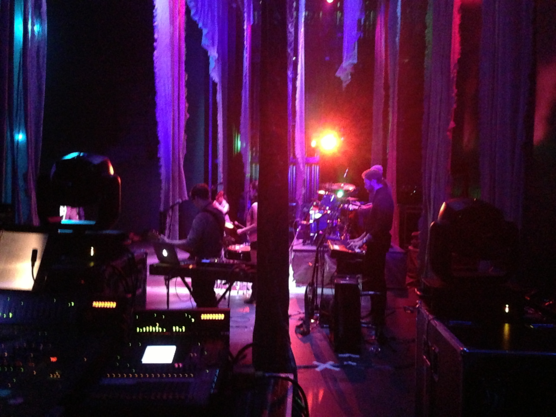 Medea — FOH POV of the band under purple and red wash