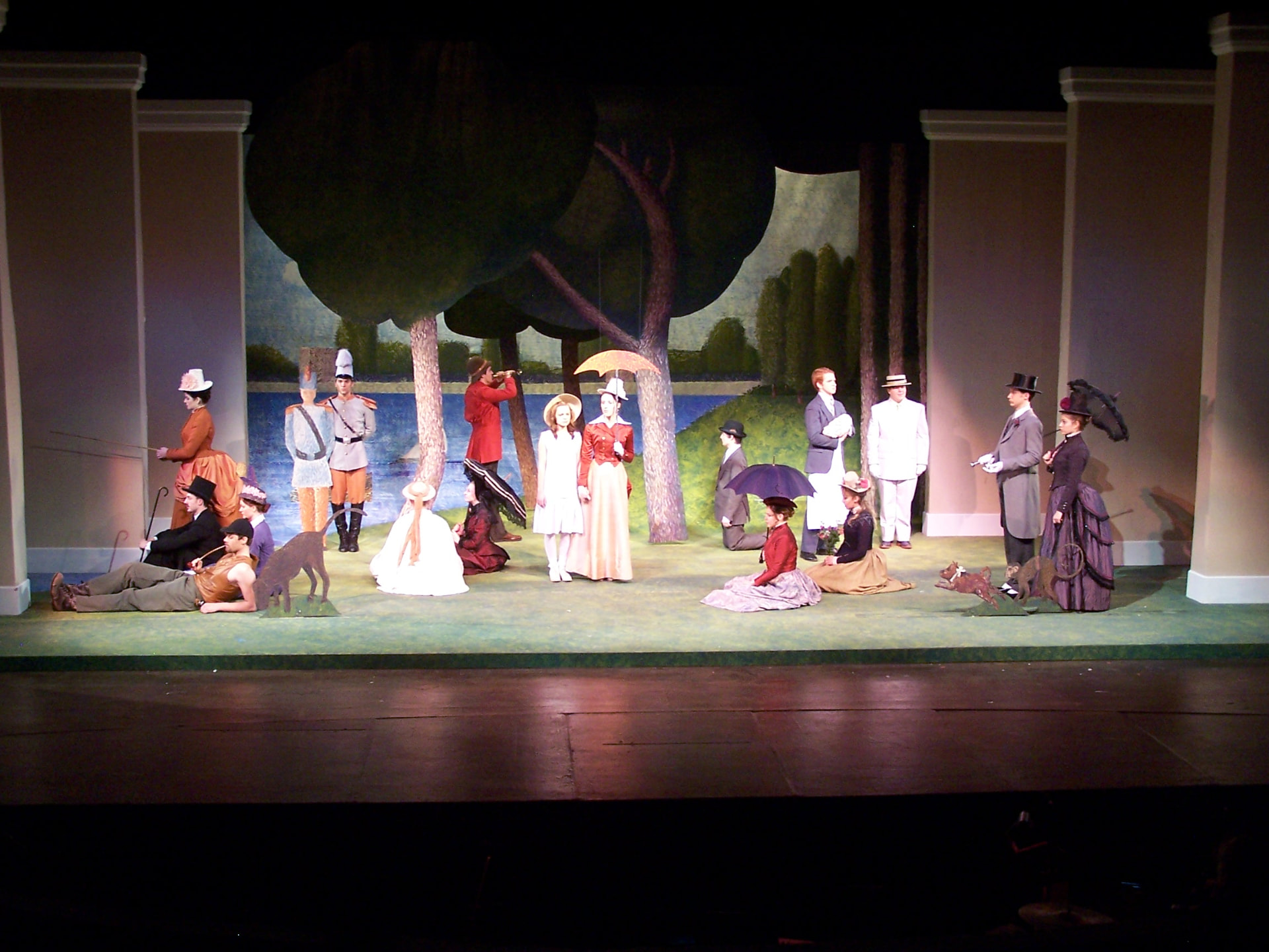 Sunday In The Park With George — the company posed across the painted Grande Jatte landscape in period dress