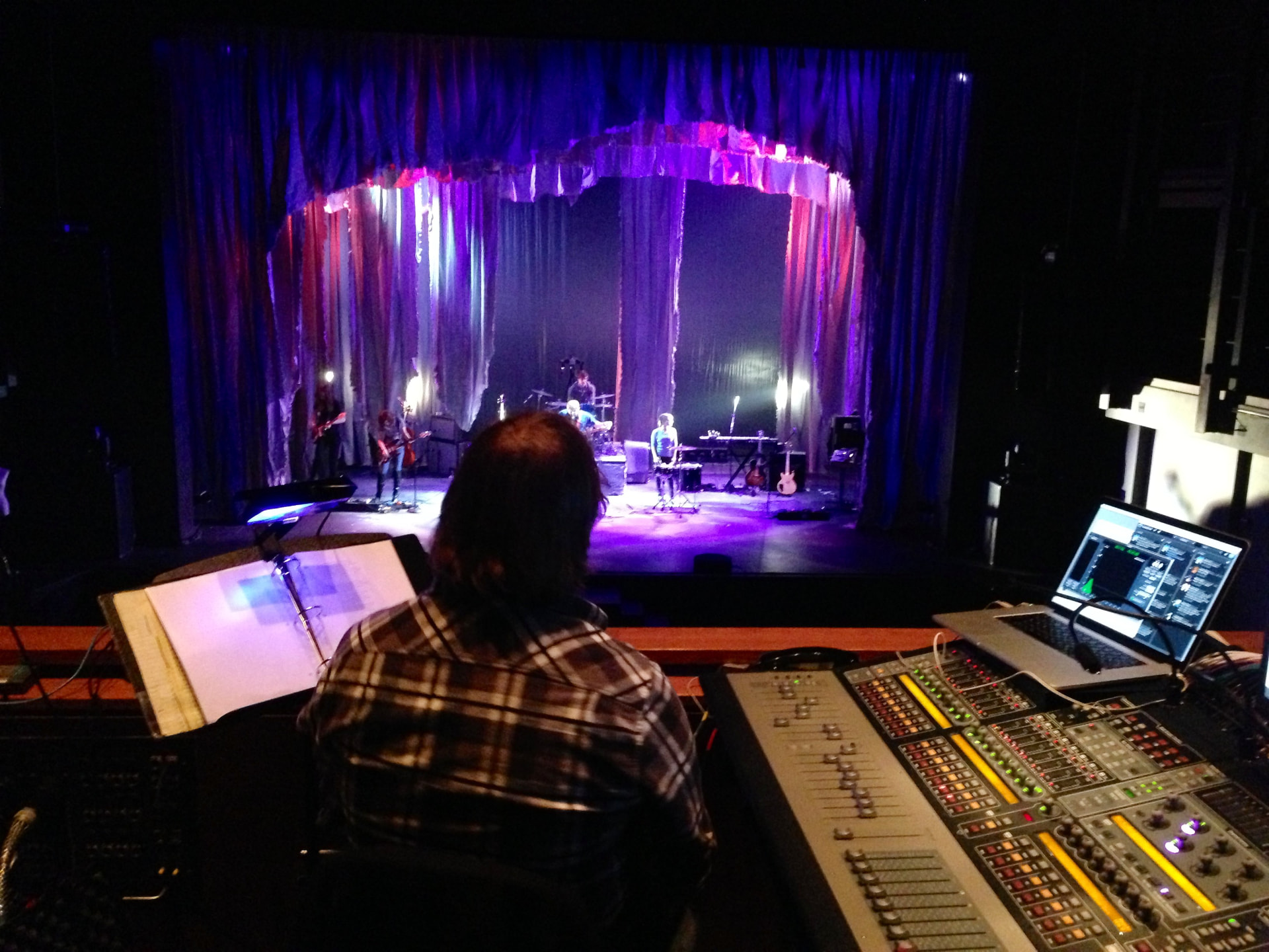 Medea — FOH mix position looking at the shredded-curtain set with onstage band