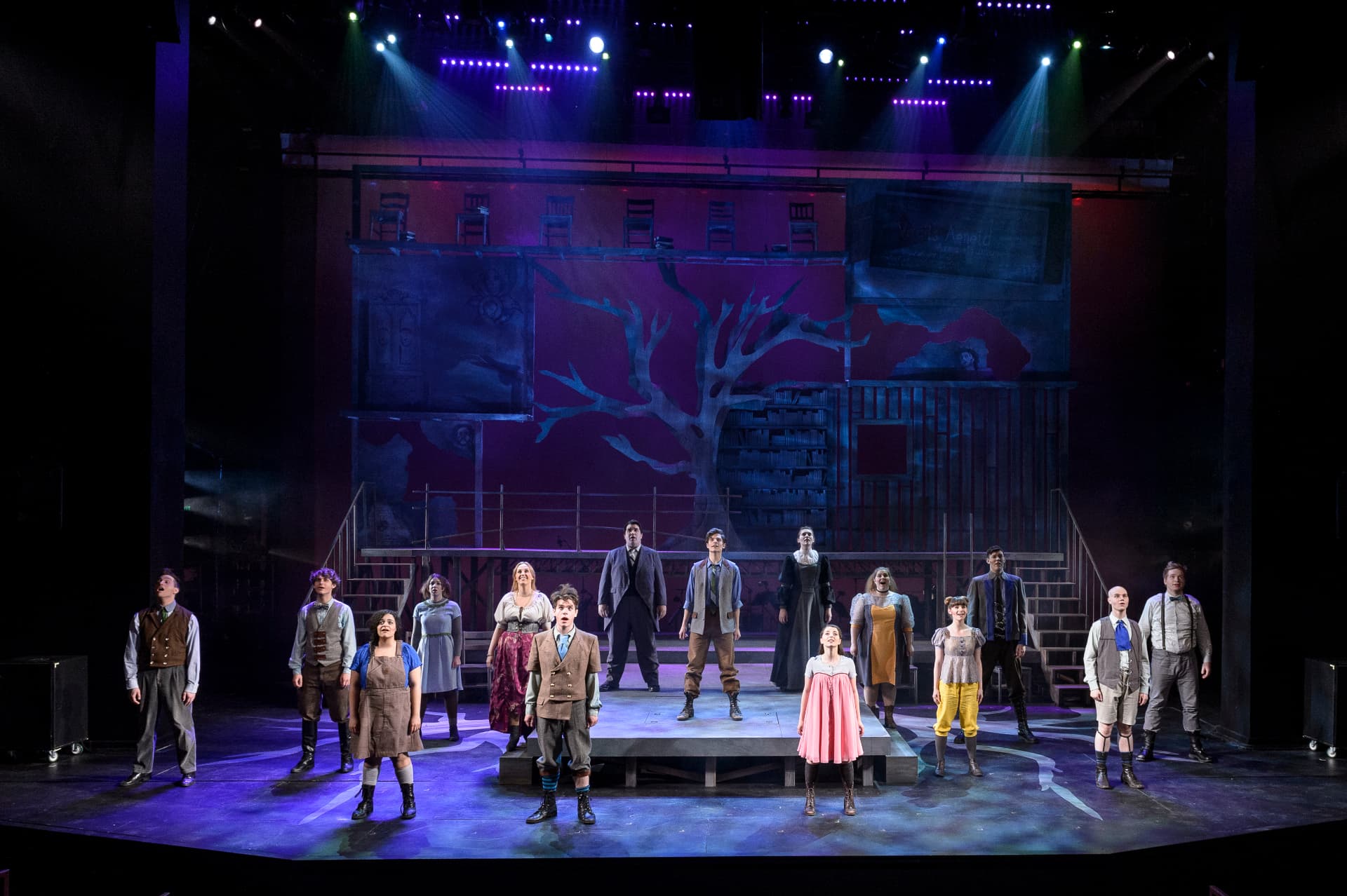 Spring Awakening — full company under the tree backdrop