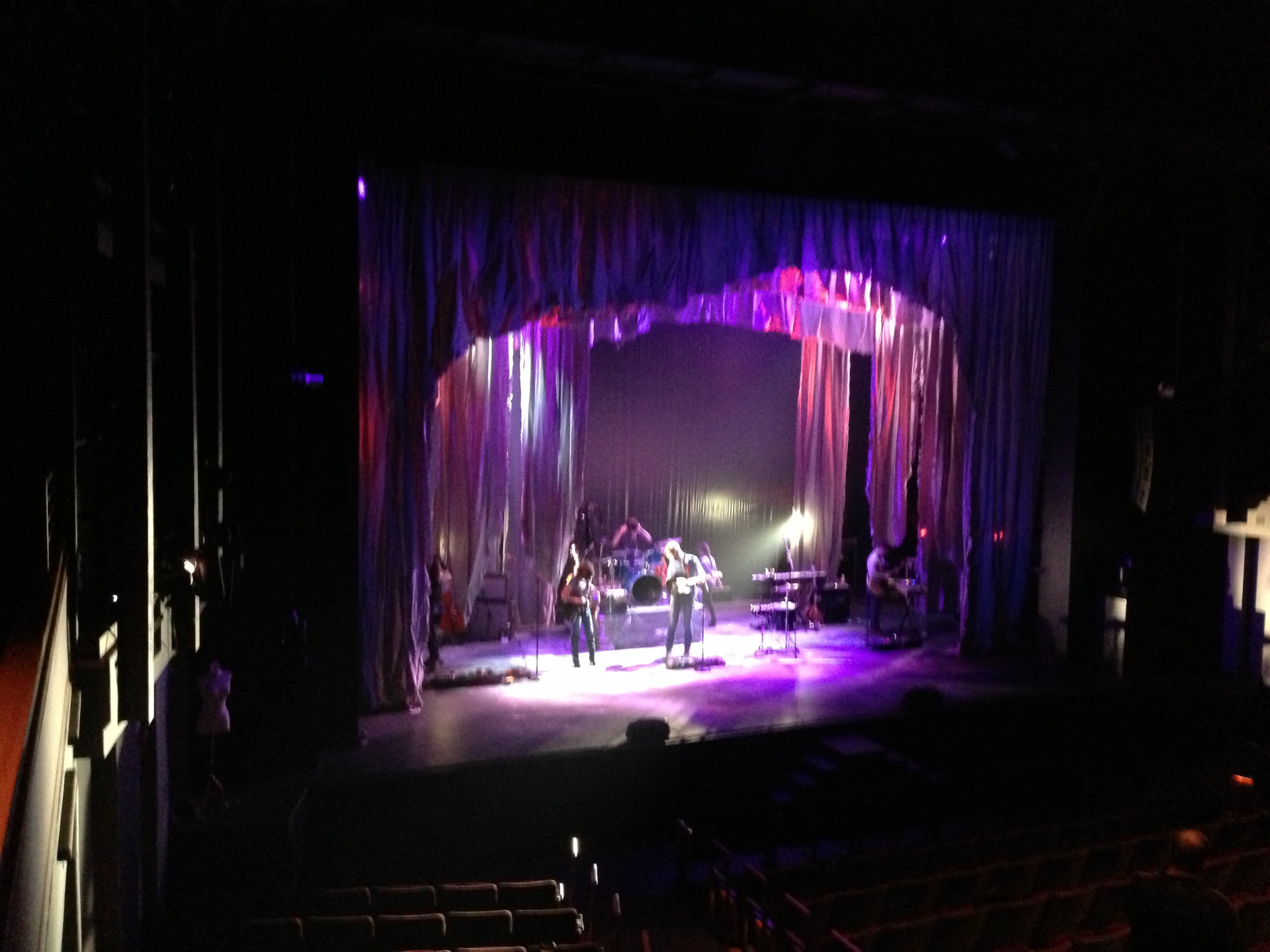 Medea — wide view of the shredded-curtain set from the house