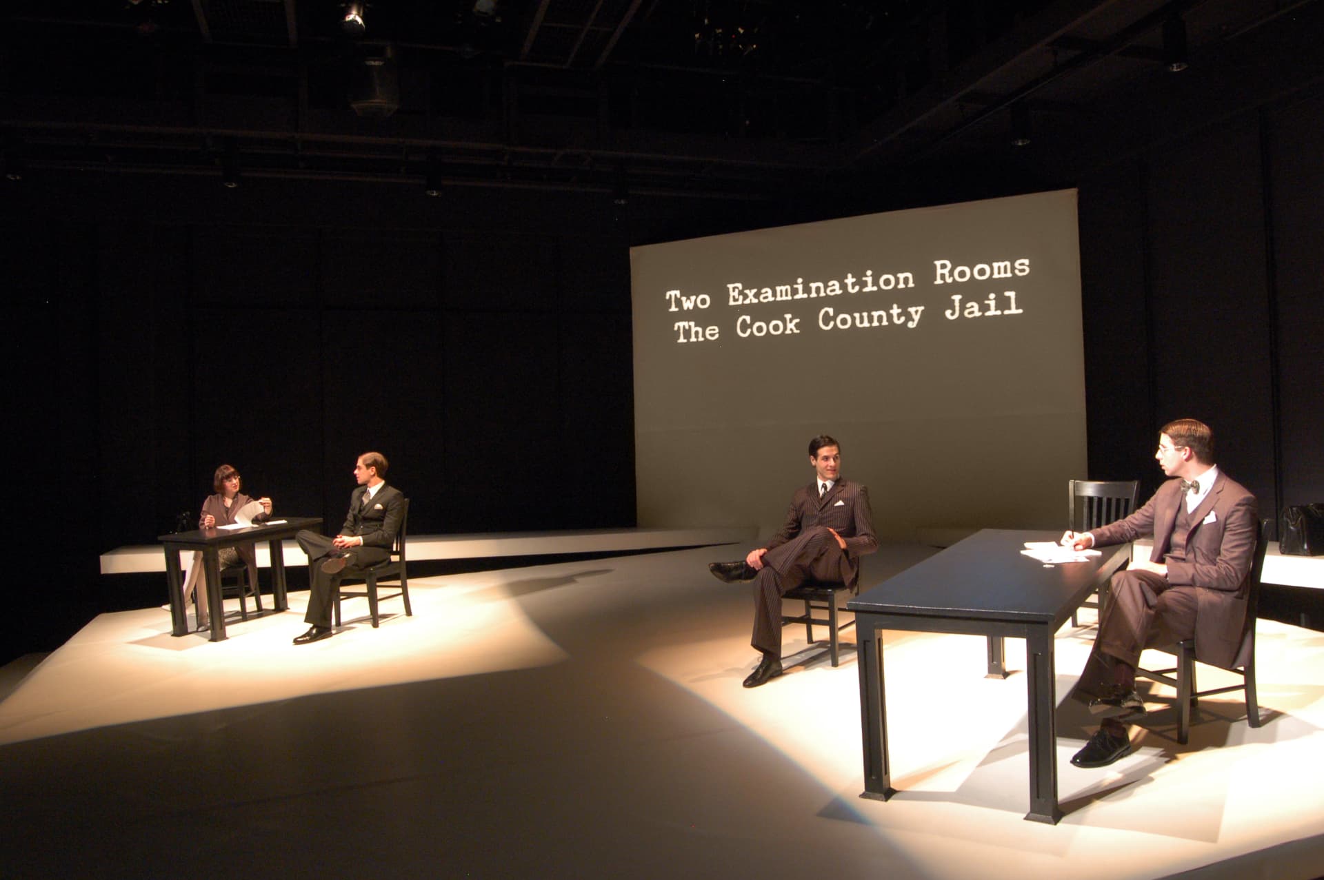 Never The Sinner — 'Two Examination Rooms, The Cook County Jail' title projection over parallel interrogations